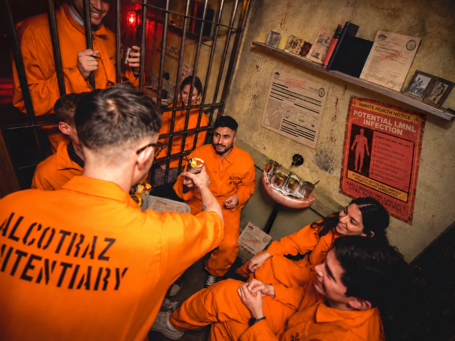 Guests receiving cocktails inside an Alcotraz prison cell
